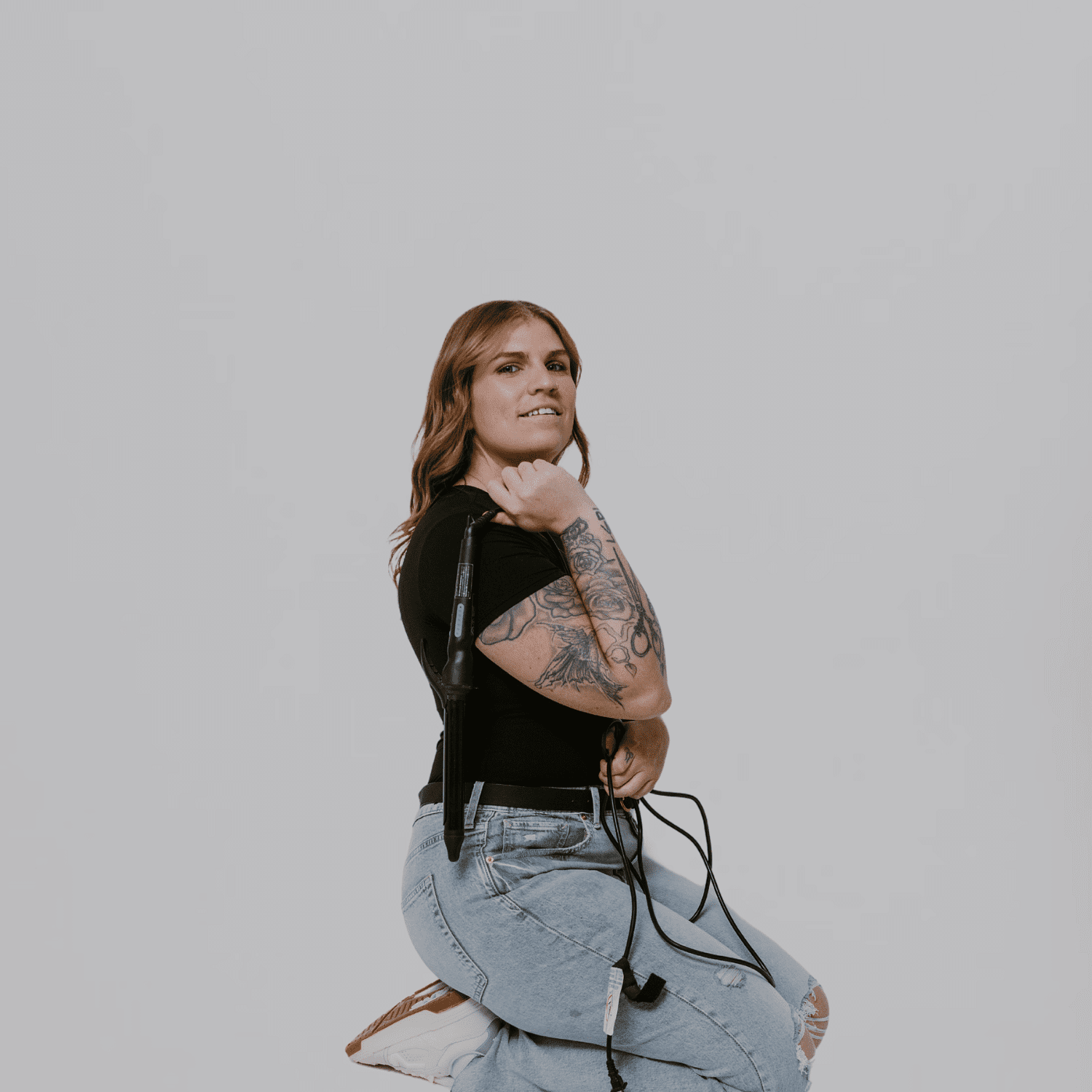 Portrait of Jess, a professional stylist at The Gloss Society, showcasing their expertise and style.