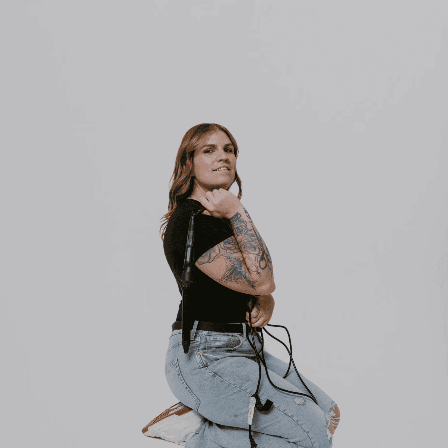 Portrait of Jess, a professional stylist at The Gloss Society, showcasing their expertise and style.