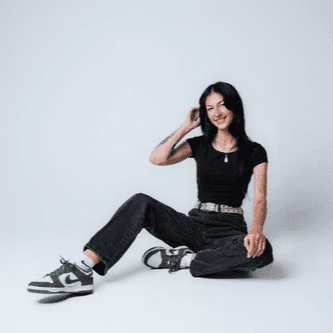 Portrait of Elyssa, a professional stylist at The Gloss Society, showcasing their expertise and style.