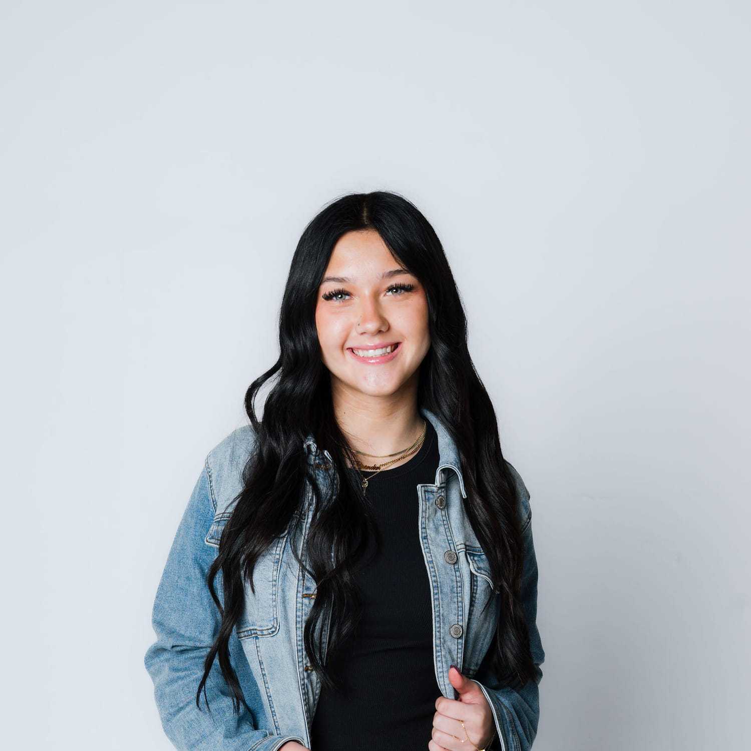 Portrait of Norah, a professional stylist at The Gloss Society, showcasing their expertise and style.