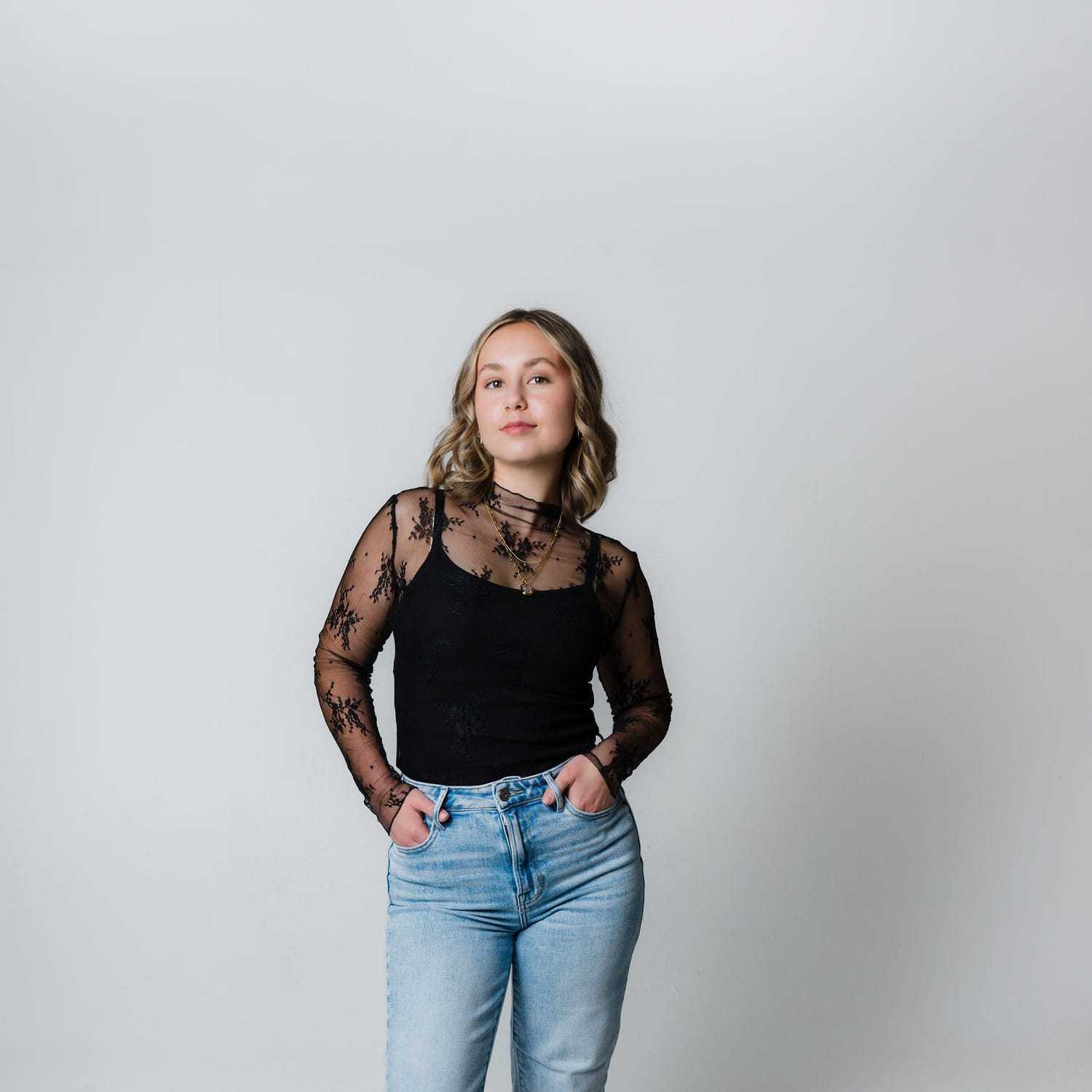 Portrait of Macy, a professional stylist at The Gloss Society, showcasing their expertise and style.