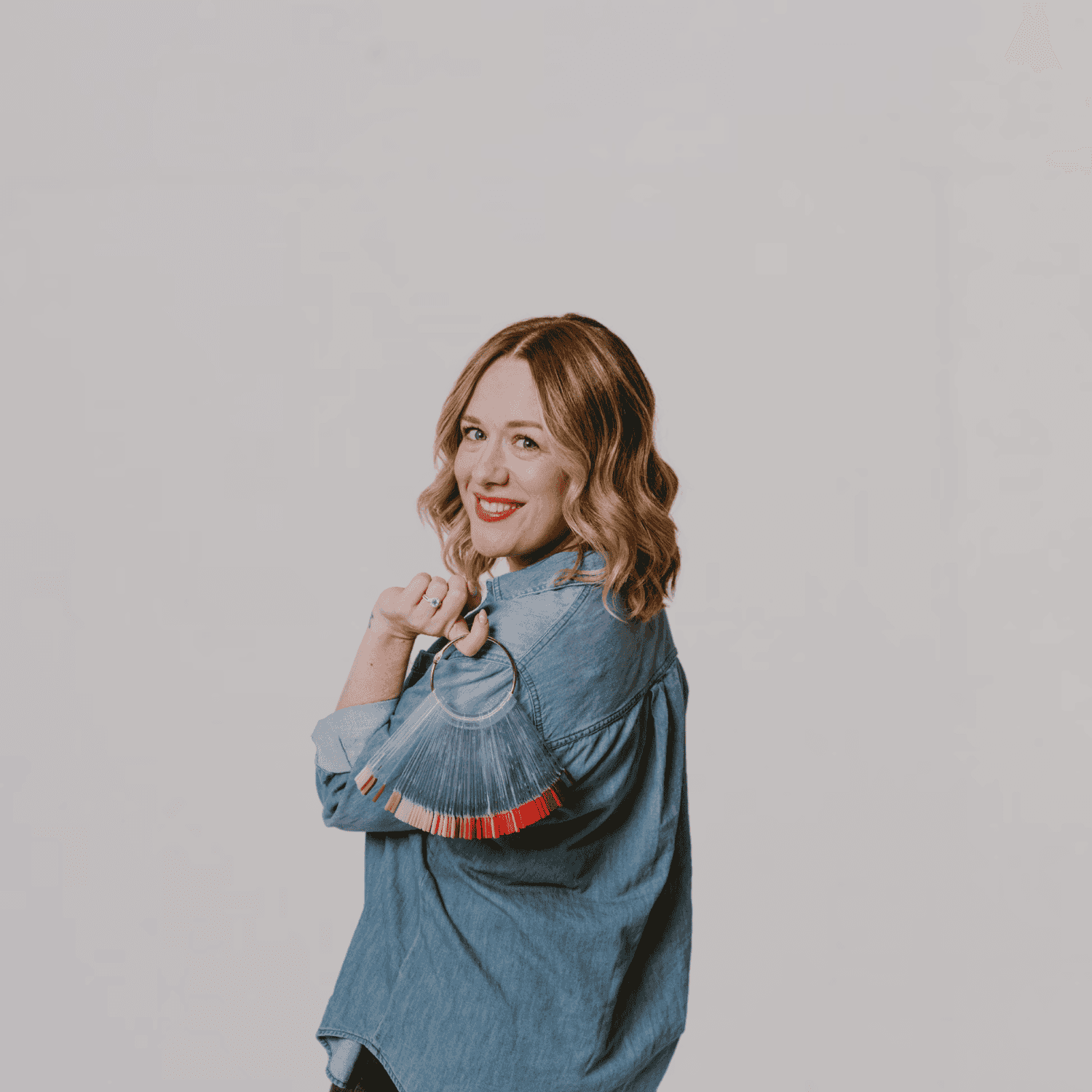 Portrait of Briana, a professional stylist at The Gloss Society, showcasing their expertise and style.